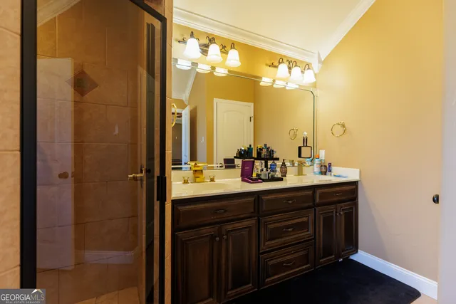 a bathroom with a double vanity sink and mirror with shower