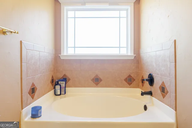 a bathroom with a tub and a window