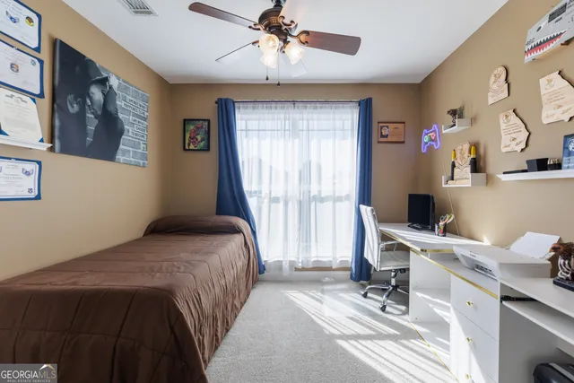 a bedroom with a bed and a desk