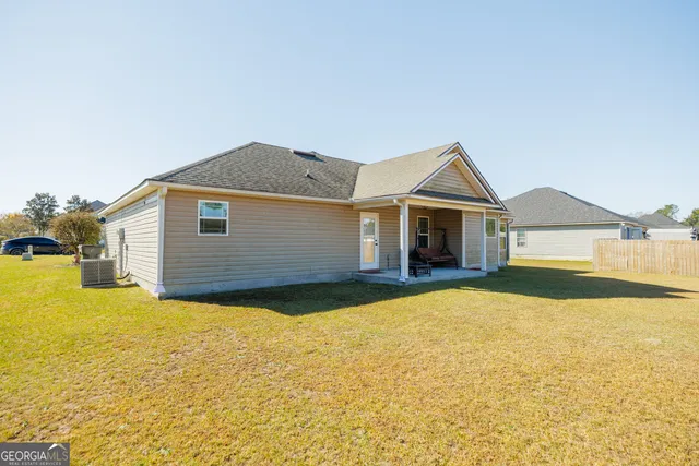 a view of a house with swimming pool and a yard