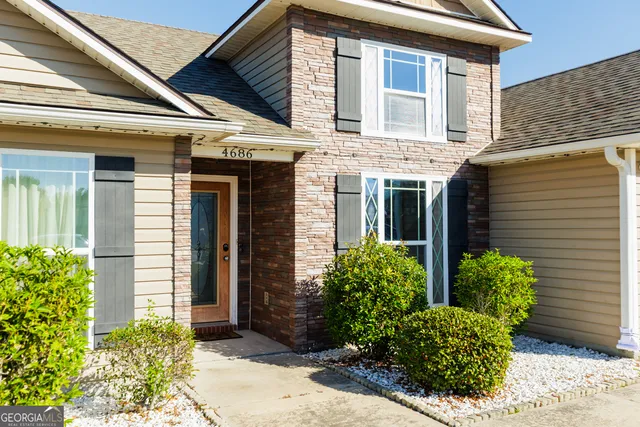 a view of a house with potted plants