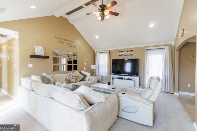 a living room with furniture and a flat screen tv
