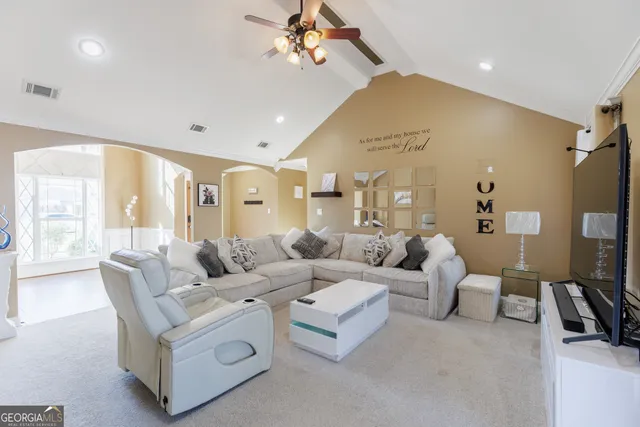 a living room with furniture and a large window