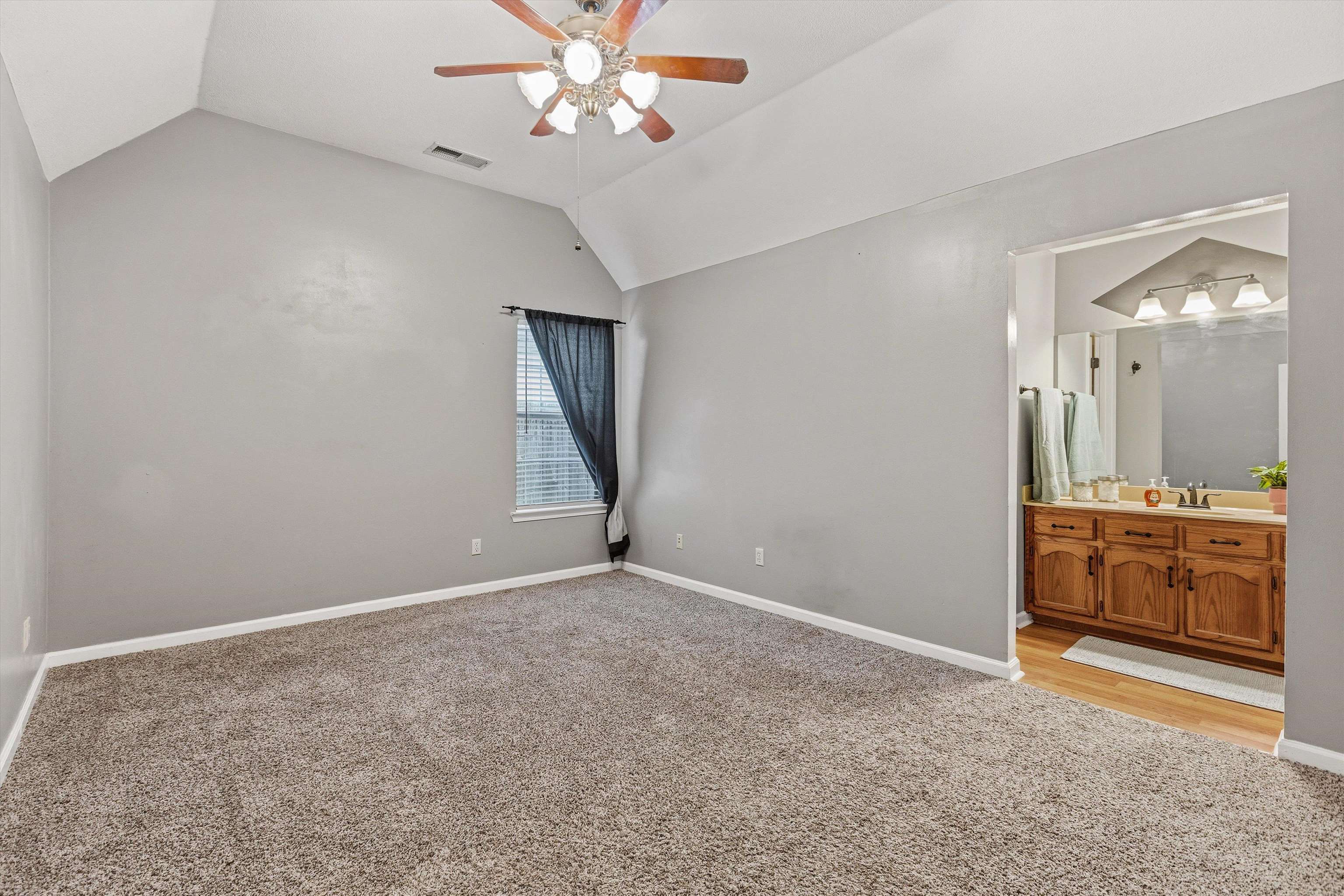 1379 Lagrange Downs Road Cordova, TN 38018 - Photo 13 of 35 Carpeted room featuring a vaulted ceiling and a ceiling fan with light fixture