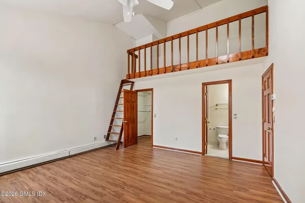 a view of an entryway with wooden floor