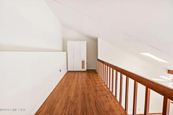 a view of a hallway with wooden floor