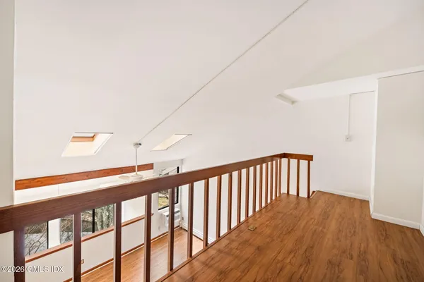 a view of a hallway with wooden floor
