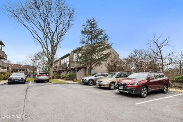 a view of cars parked on the side of a street