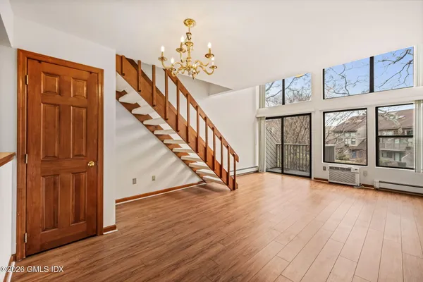 a view of an entryway with wooden floor
