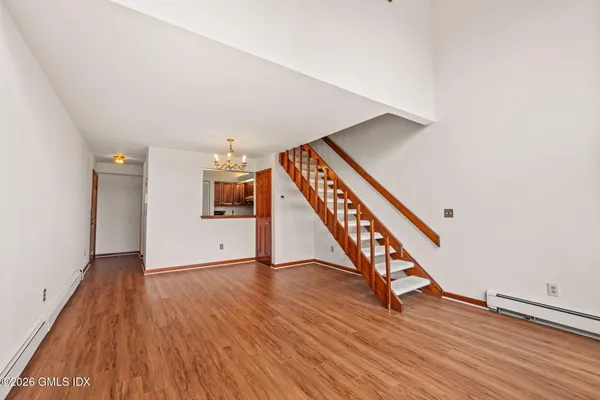 a view of an entryway with wooden floor