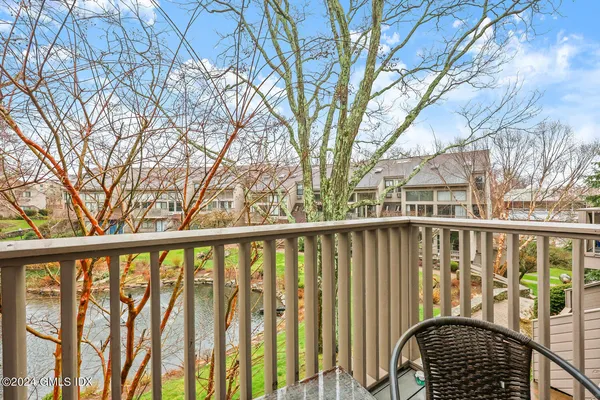 a view of a balcony with wooden fence and floor