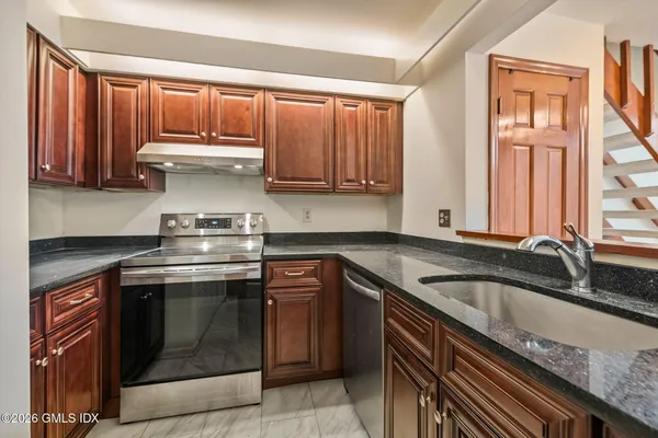 a kitchen with a sink stove and cabinets