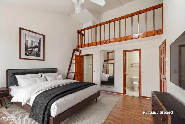 a bedroom with bed and a window