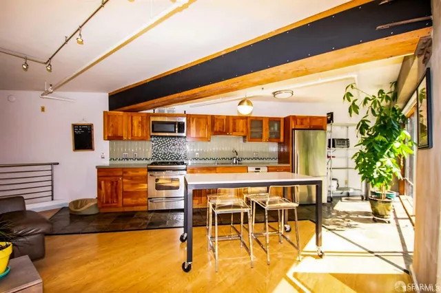 a kitchen with stainless steel appliances granite countertop a sink and cabinets