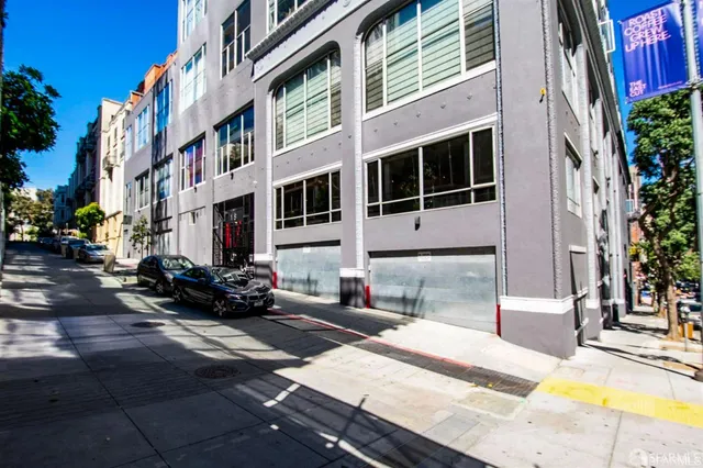 a view of a hallway with wooden floor and glass door