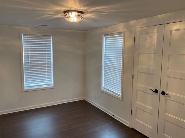 5919 River Road Flowery Branch, GA 30542 - Photo 11 of 18 a view of an empty room with a window and wooden floor