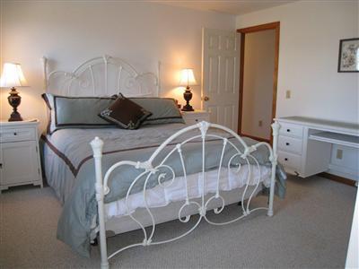 70 Meridian Way Barnstable, MA 02630 - Photo 9 of 29 a bedroom with a bed and a chandelier