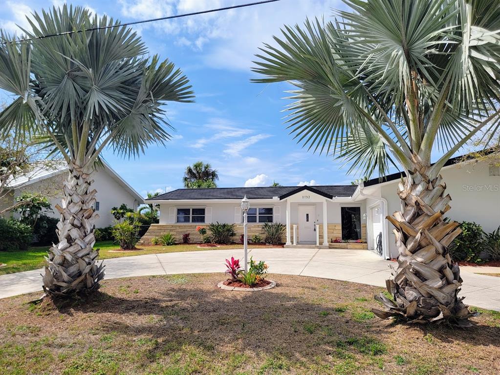 1732 Boca Raton Court Punta Gorda, FL 33950 - Photo 1 of 64 a front view of a house with a garden and trees