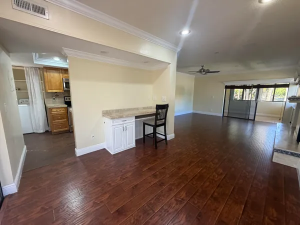 a view of a livingroom with furniture and hardwood floor