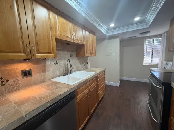 a kitchen with a sink stove and cabinets