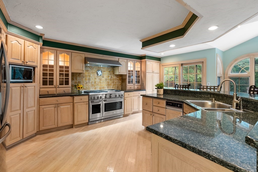 4 Standish Drive Canton, MA 02021 - Photo 4 of 32 a kitchen with stainless steel appliances granite countertop a stove a sink and a microwave