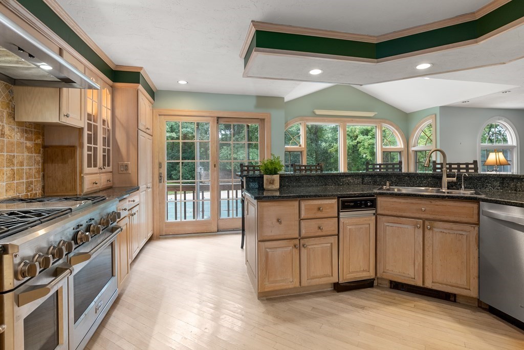 4 Standish Drive Canton, MA 02021 - Photo 8 of 32 a kitchen with stainless steel appliances granite countertop a stove and a sink