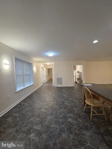 a view of a room with furniture and window