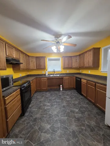 a large kitchen with lots of counter space and a sink