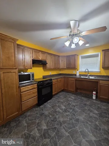 a kitchen with stainless steel appliances granite countertop a sink and cabinets