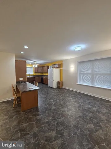 a view of backyard with barbeque grill and outdoor seating