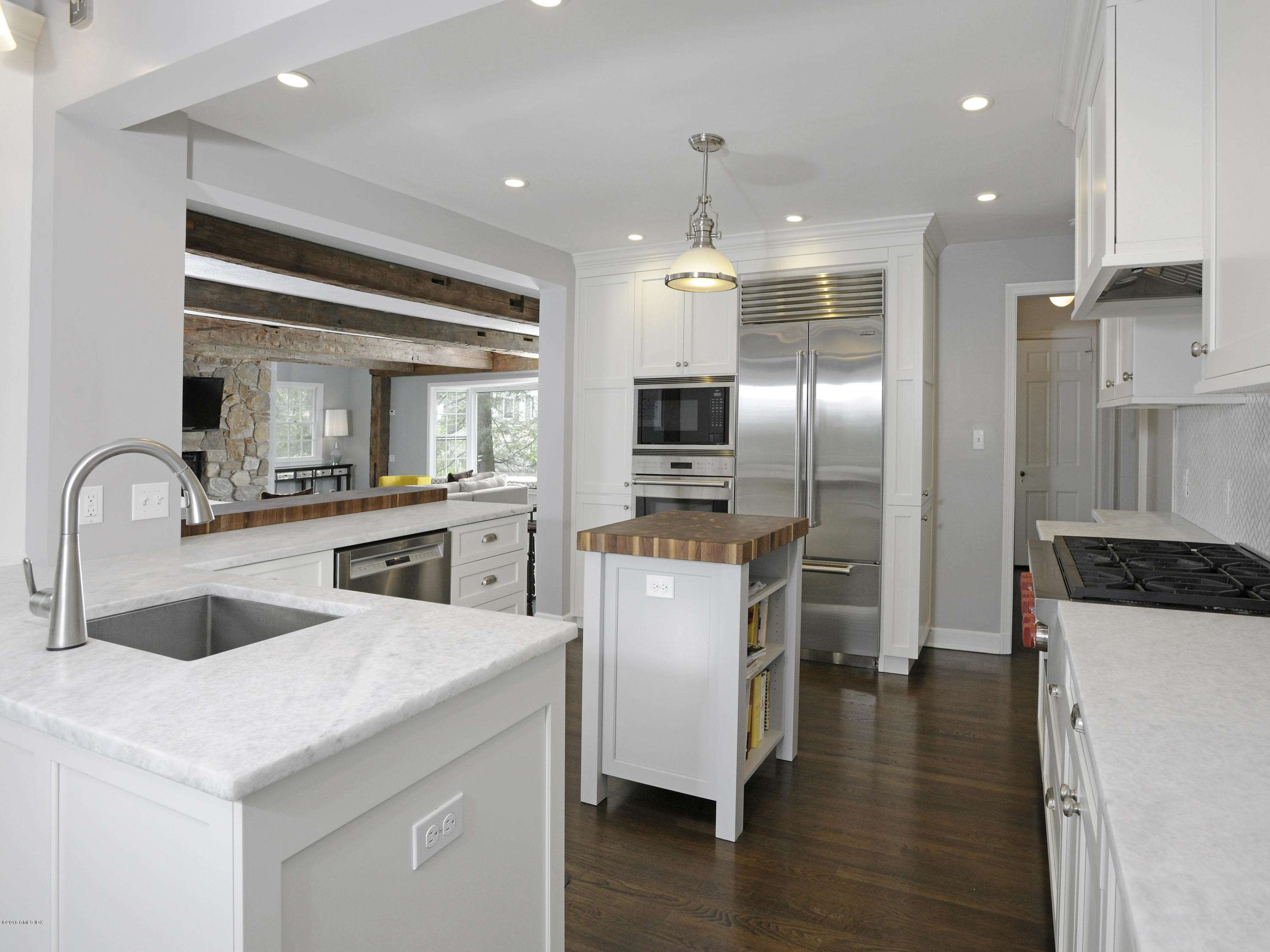12 Wesskum Wood Road Riverside, CT 06878 - Photo 13 of 41 a kitchen with a sink stainless steel appliances and wooden floor