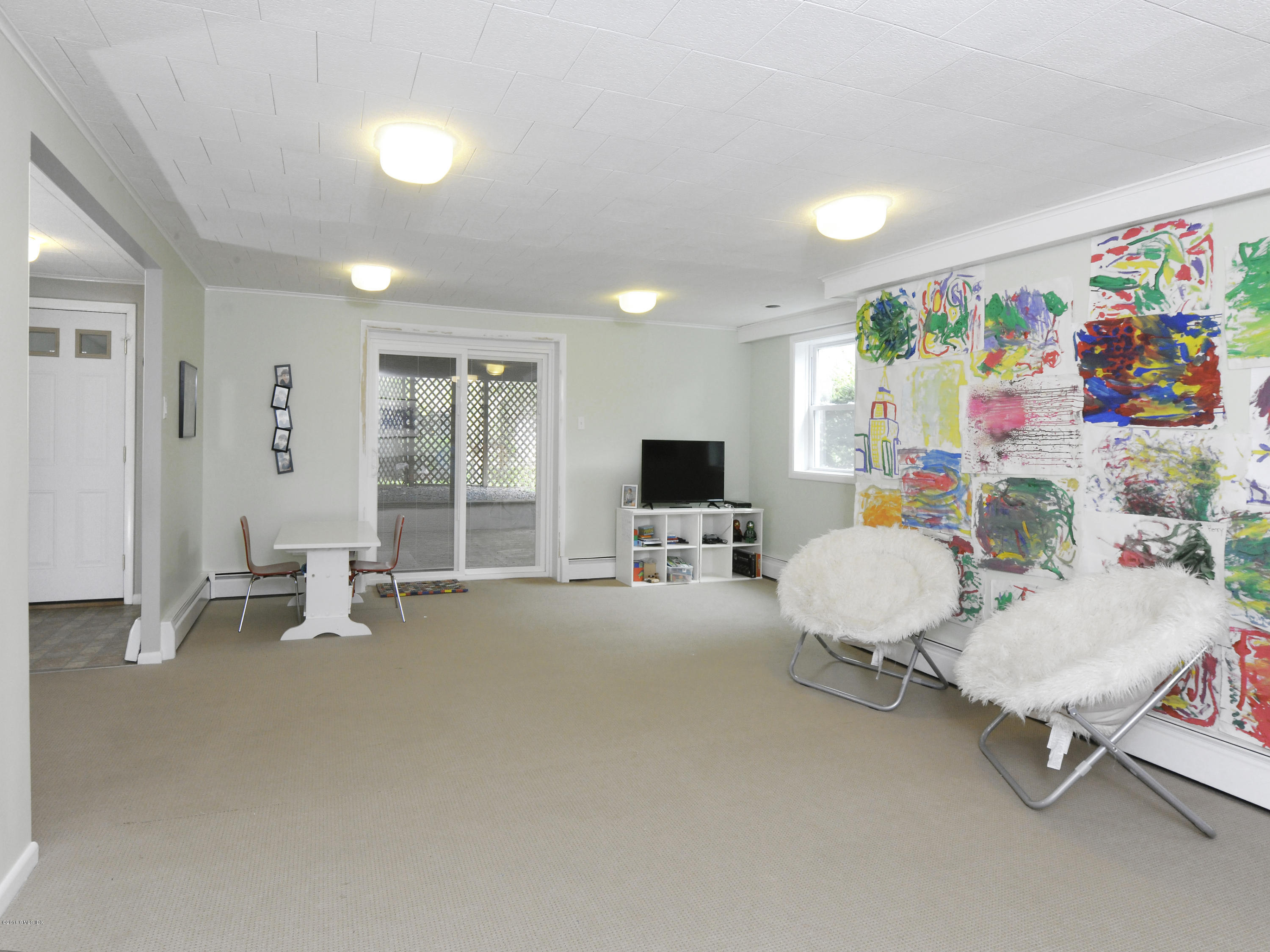 12 Wesskum Wood Road Riverside, CT 06878 - Photo 28 of 41 a room with furniture and a flat screen tv
