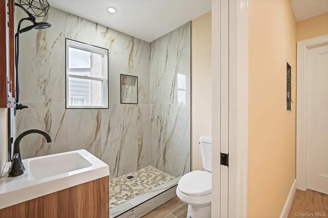 a bathroom with a sink toilet and shower