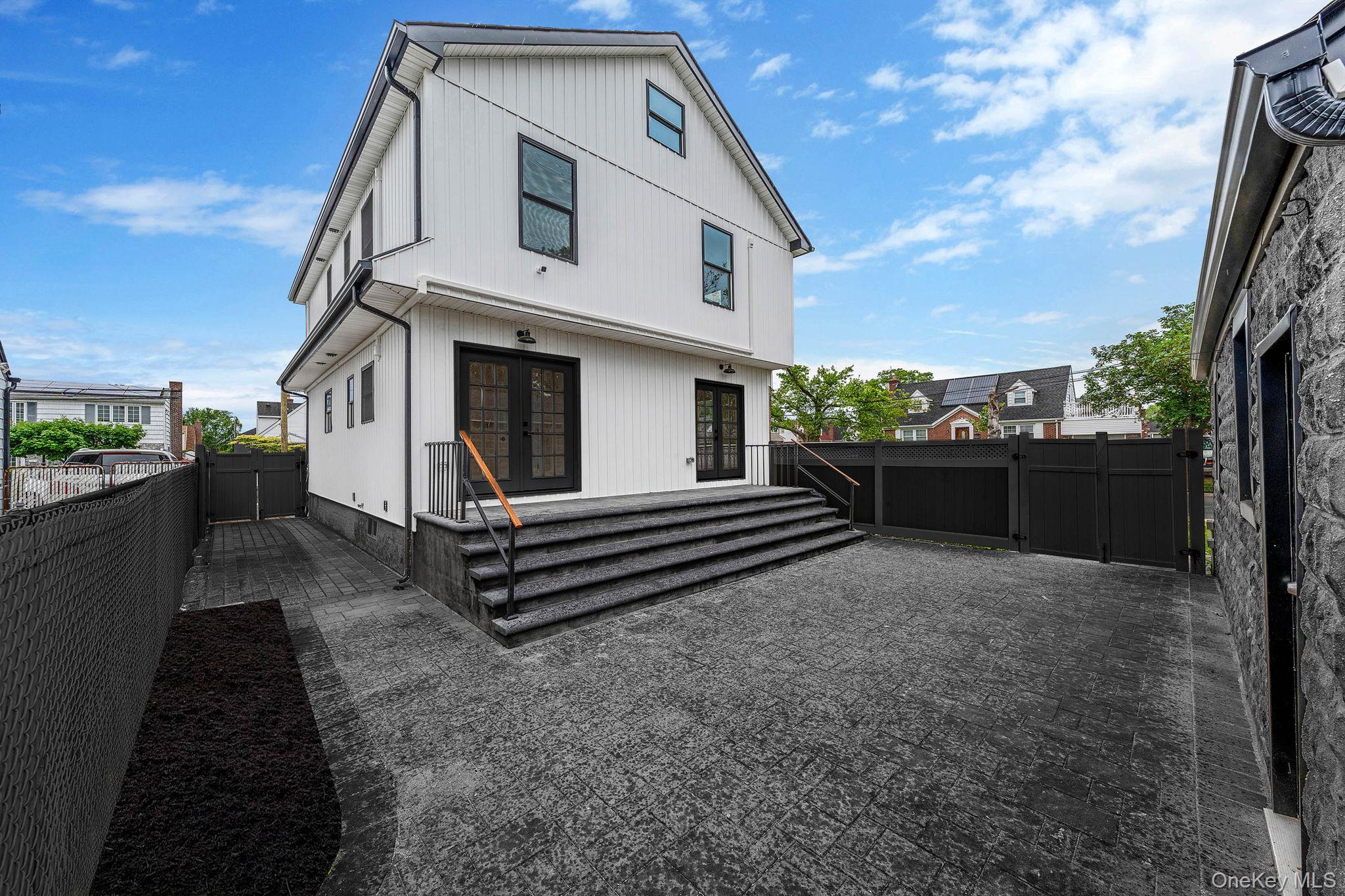 87 Sobro Avenue Valley Stream, NY 11580 - Photo 2 of 20 a front view of a house with a garden