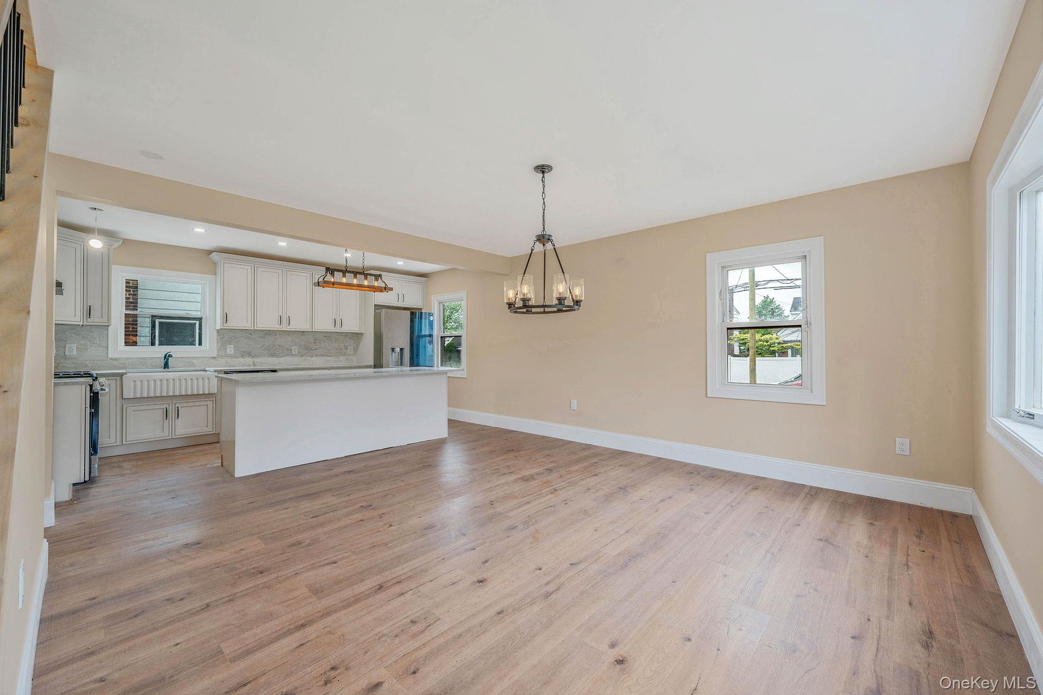 87 Sobro Avenue Valley Stream, NY 11580 - Photo 8 of 20 a view of a kitchen with a sink dishwasher a refrigerator and wooden floor