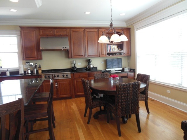 509 Phillippa Street Hinsdale, IL 60521 - Photo 7 of 20 a kitchen with stainless steel appliances granite countertop a dining table chairs and a refrigerator