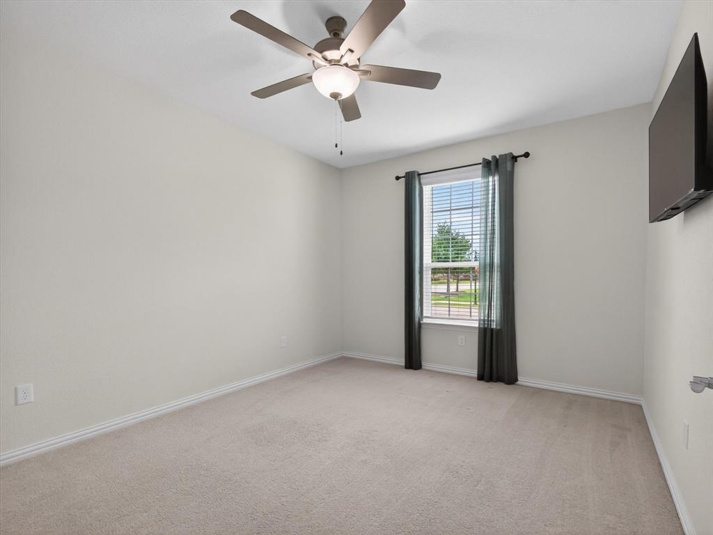 636 Corner Post Path Celina, TX 75009 - Photo 23 of 40 Carpeted secondary room down with a ceiling fan light fixture, a window with horizontal blinds, and a wall-mounted display