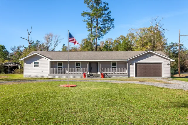 a house view with a sitting space and garden