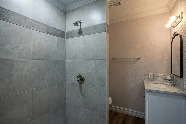 a bathroom with a granite countertop sink a shower and a mirror