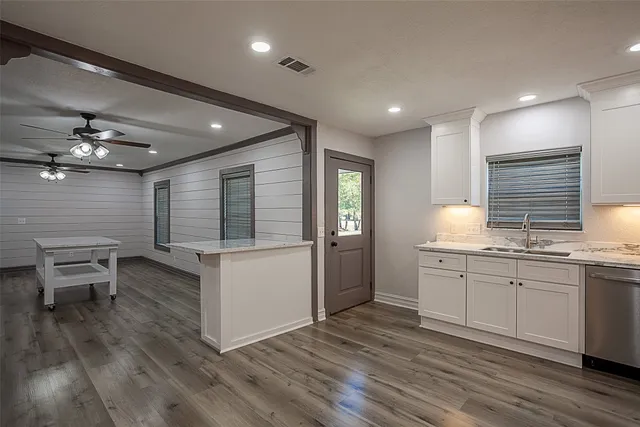 a kitchen with sink cabinets and wooden floor