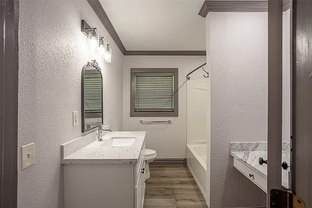 a bathroom with a sink and mirror with window