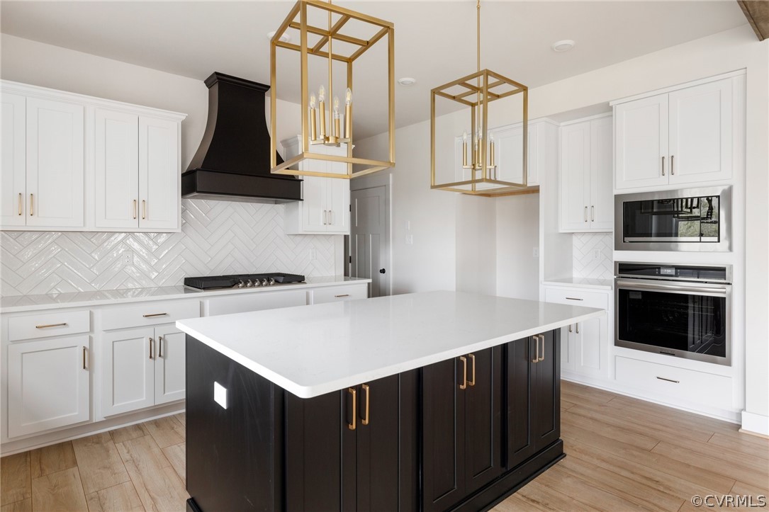 15142 Heaton Drive Midlothian, VA 23112 - Photo 11 of 41 a kitchen with stainless steel appliances a stove a sink cabinets and a wooden floor