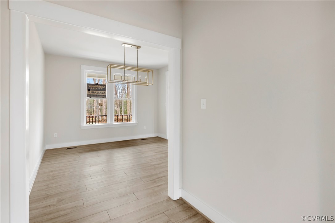 15142 Heaton Drive Midlothian, VA 23112 - Photo 13 of 41 a view of an empty room with wooden floor and a window