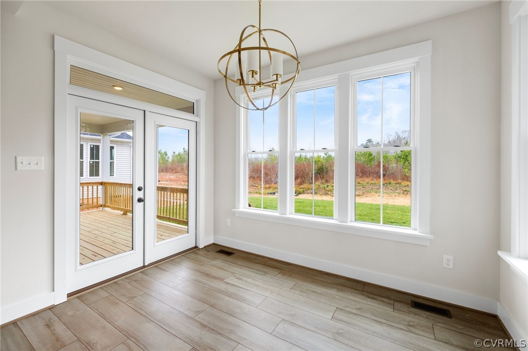15142 Heaton Drive Midlothian, VA 23112 - Photo 14 of 41 a view of an empty room with a window and wooden floor