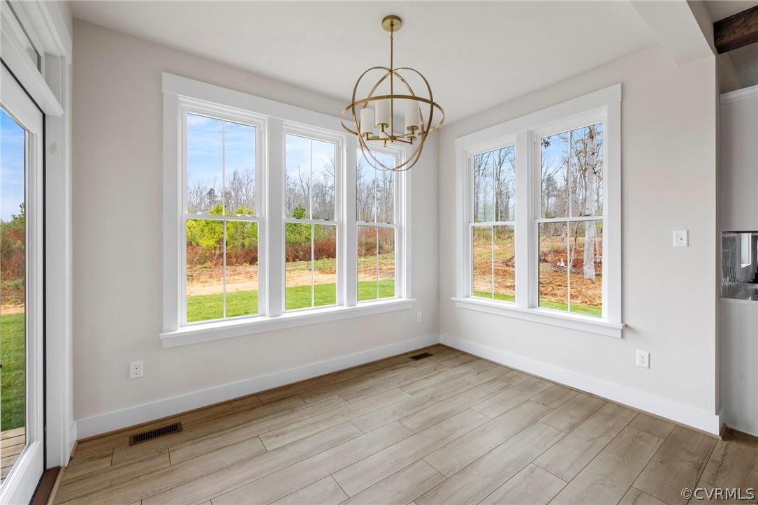 15142 Heaton Drive Midlothian, VA 23112 - Photo 15 of 41 a view of an empty room with wooden floor and windows