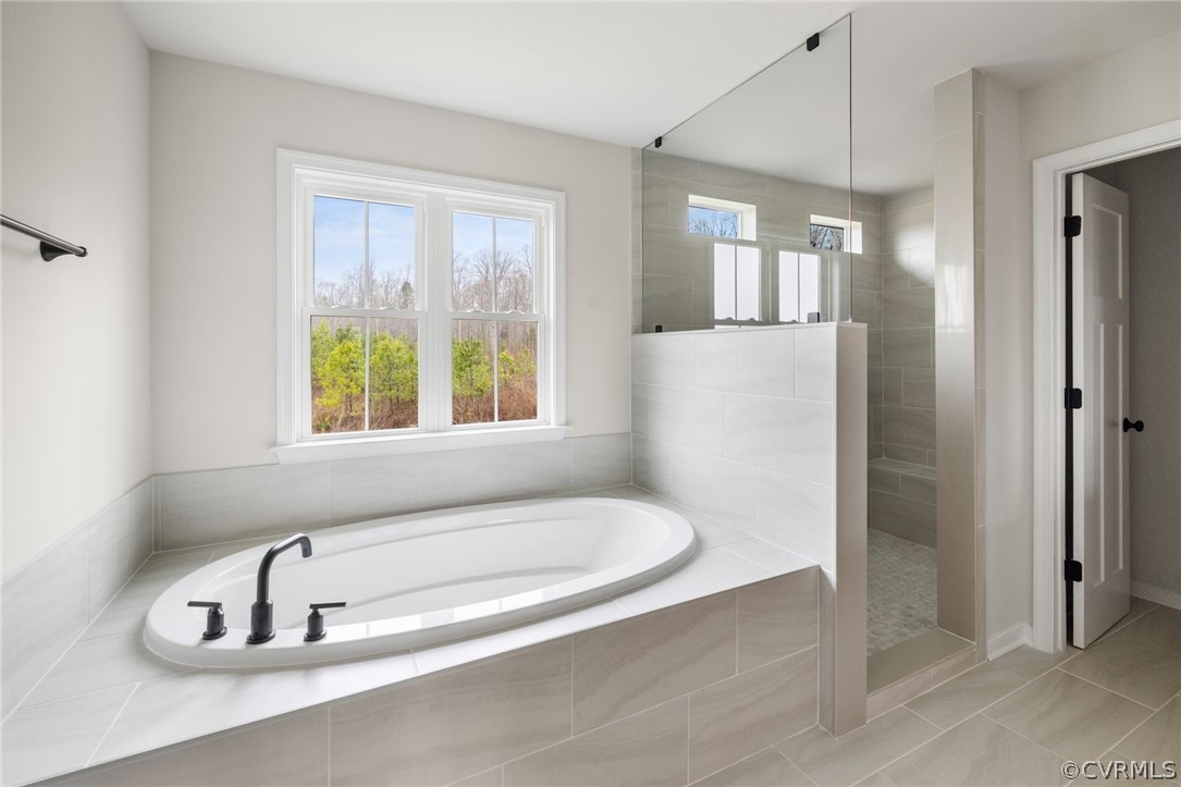 15142 Heaton Drive Midlothian, VA 23112 - Photo 26 of 41 a bathroom with a tub a sink and a window