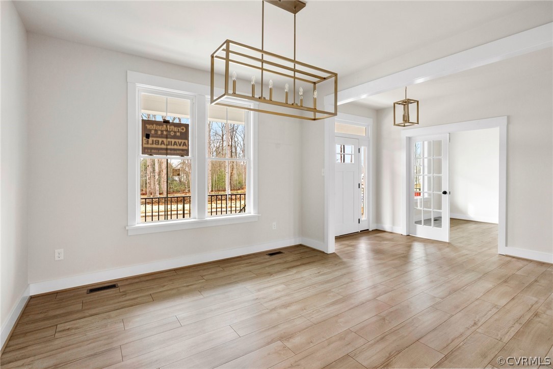 15142 Heaton Drive Midlothian, VA 23112 - Photo 9 of 41 a view of an empty room with wooden floor and a window
