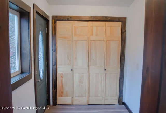 a view of an entryway with wooden floor