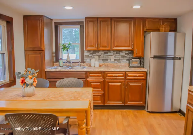 a kitchen with stainless steel appliances granite countertop a refrigerator and a sink