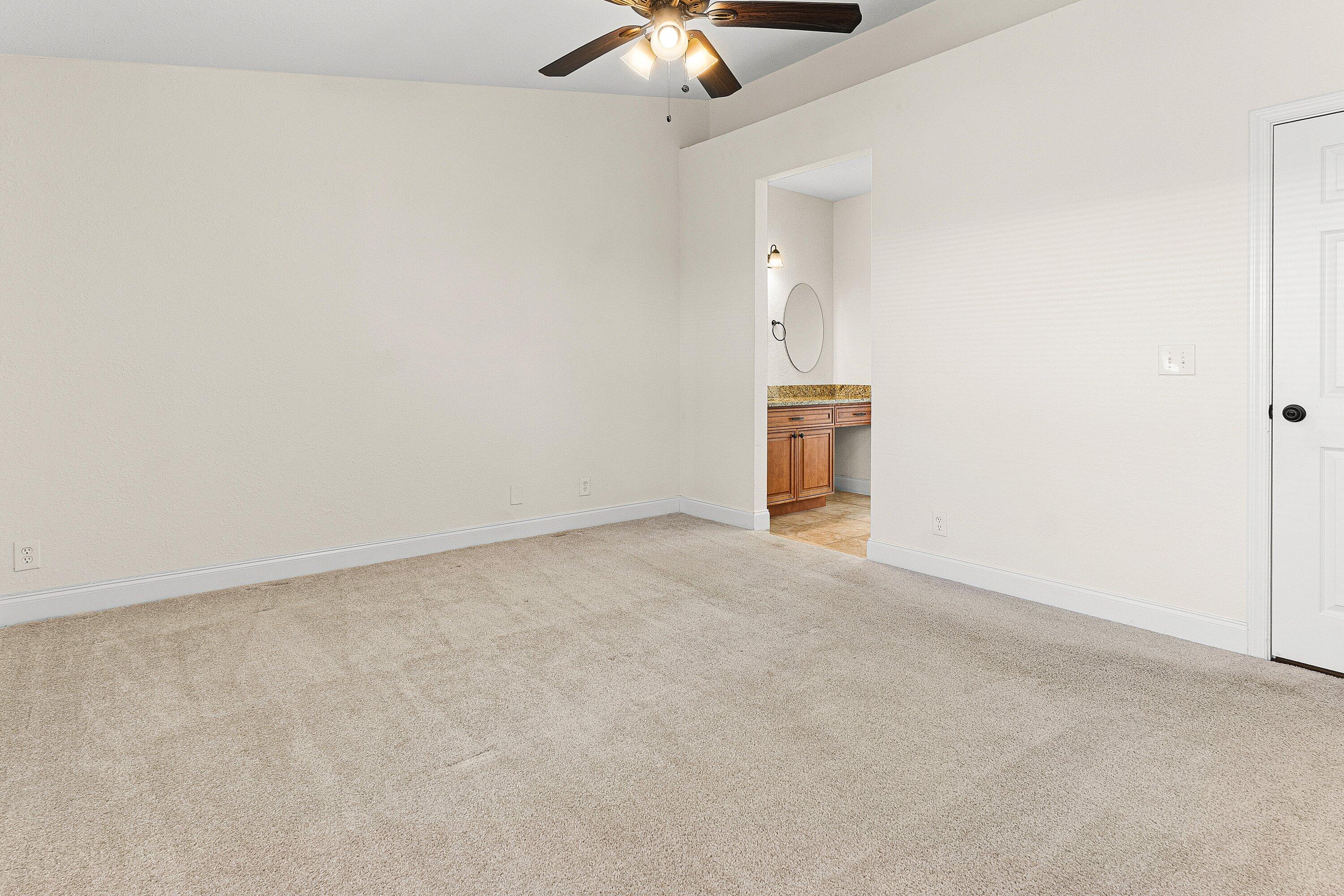 6081 Heliconia Road Delray Beach, FL 33484 - Photo 20 of 39 an empty room with a ceiling fan and a window
